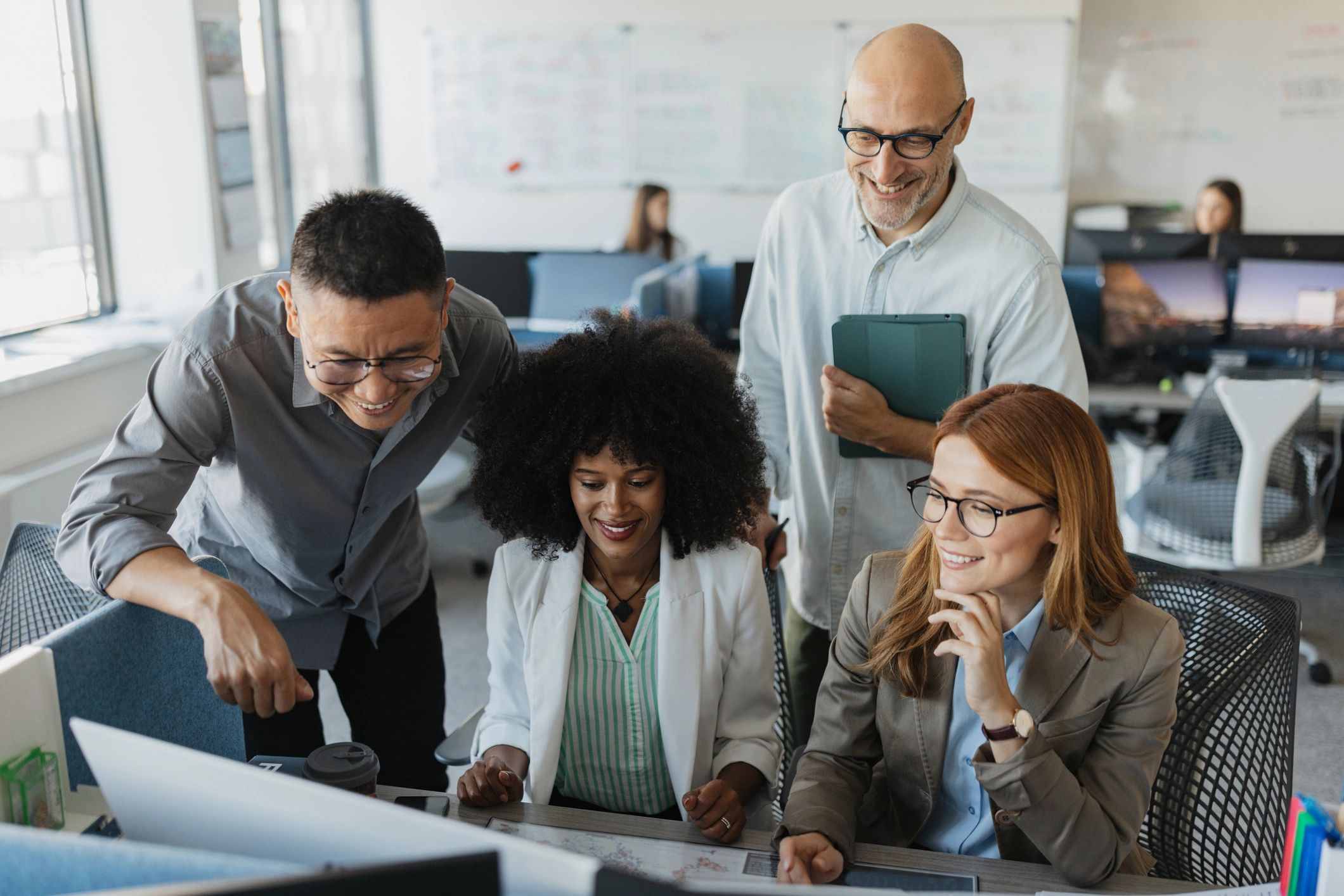 product manager collaborating with team reviewing roadmap modern office